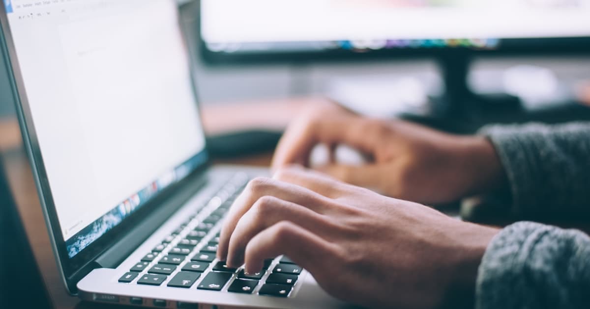 Developer working on software architecture at a desk with code on screen