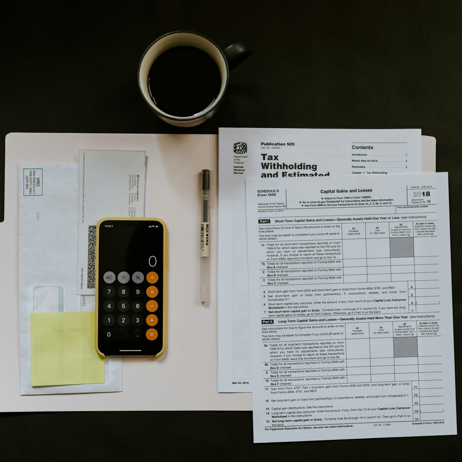 Calculator, invoices and tax paperwork on a small business desk