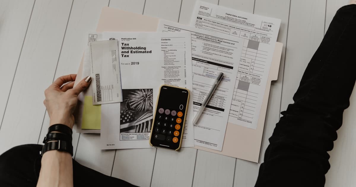 Calculator and paperwork on a desk while reviewing service costs