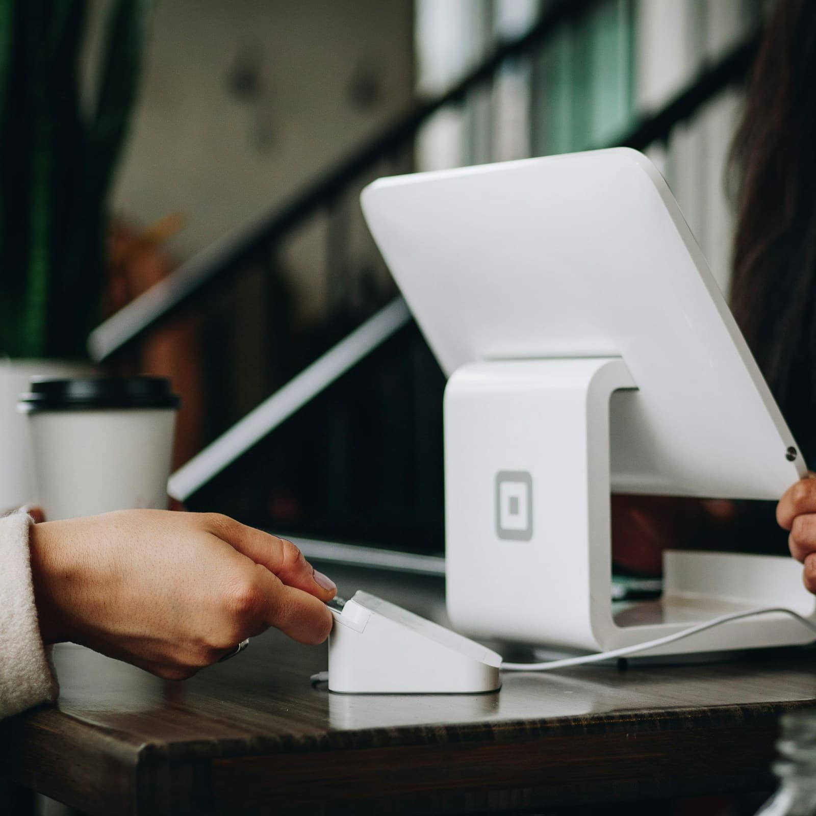 Customer paying at the counter of a small business